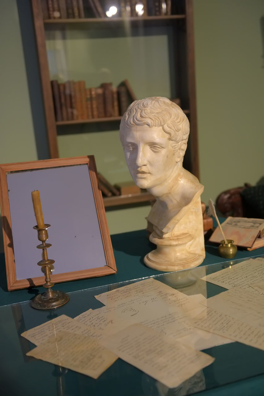 CLOSE-UP OF STATUES ON TABLE AT HOME