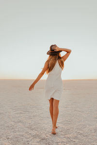 Full length of woman standing at beach