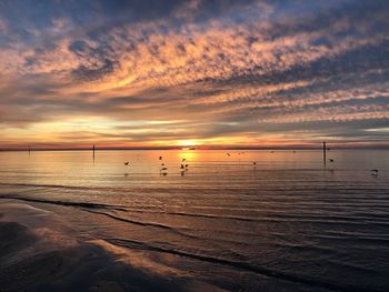 Scenic view of beach against sky during sunset