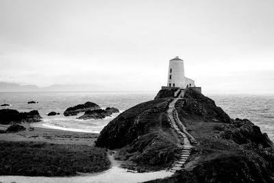 Scenic view of lighthouse near sea against sky