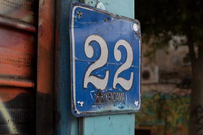 Close-up of arrow sign on wall