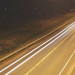 Road against sky at night