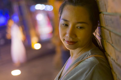 Portrait of smiling woman at night