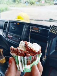 Close-up of hand holding ice cream cone