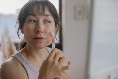 Portrait of young woman holding cigarette