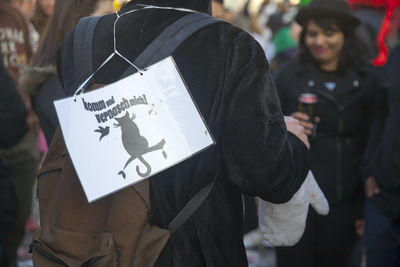 Close-up of woman holding text