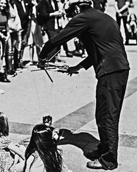 Man with umbrella on street in city