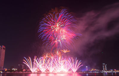 Low angle view of firework display at night