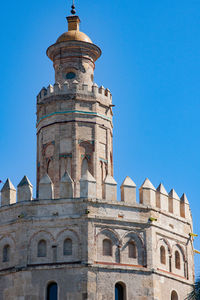 Low angle view of historic building against blue sky