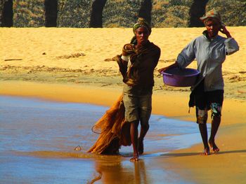 Women walking on shore at beach