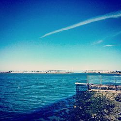 Scenic view of sea against clear blue sky