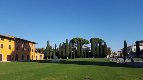 Panoramic shot of trees and houses against clear sky