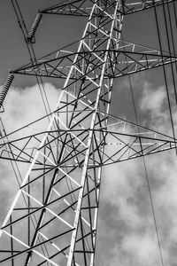 Low angle view of electricity pylon against sky
