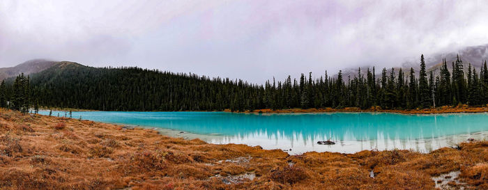 Scenic view of lake by mountains against sky