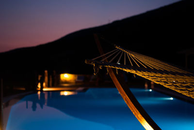 Hammock by swimming pool at dusk