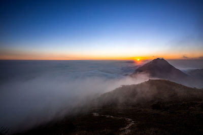 Scenic view of volcanic landscape against sky during sunset