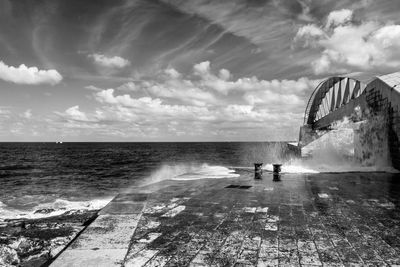 People on sea shore against sky