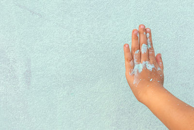 Close-up of woman hand in swimming pool