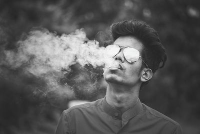 Close-up of young man smoking cigarette