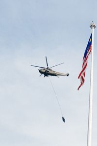 Low angle view of helicopter flying in sky