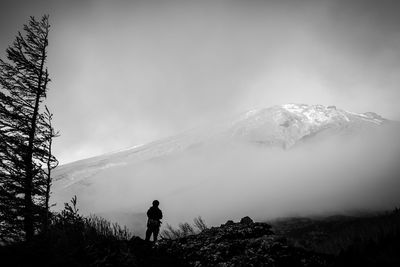 Scenic view of mountains against cloudy sky