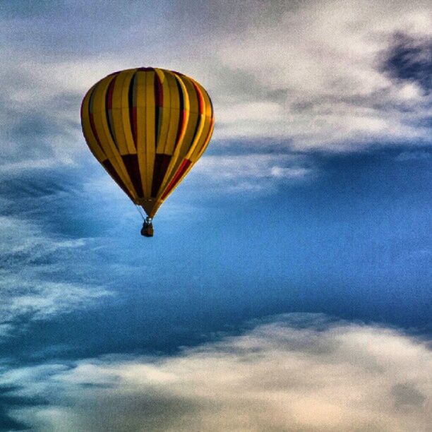 low angle view, sky, cloud - sky, mid-air, cloudy, flying, hot air balloon, cloud, multi colored, blue, beauty in nature, nature, tranquility, scenics, outdoors, tranquil scene, no people, day, weather, parachute