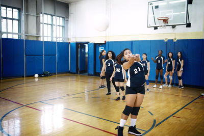 Teenage girls playing at volleyball court