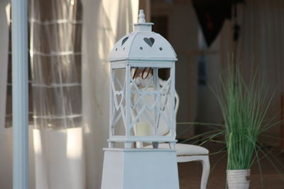 Close-up of white candles on table at home