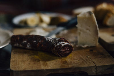 Close-up of salami and cheese on cutting board