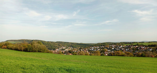 Scenic view of field against sky with village brücken in rhineland-palatinate in background.