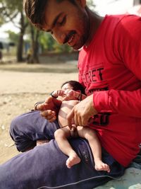 Father and son holding baby