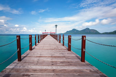 Pier over sea against sky