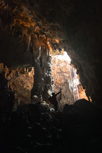 People on rock in cave