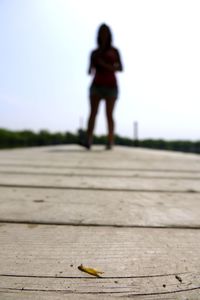 Surface level of boardwalk against clear sky