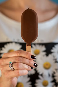 Midsection of woman holding chocolate ice cream