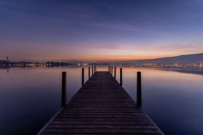 Pier over sea against sky during sunrise lake zug