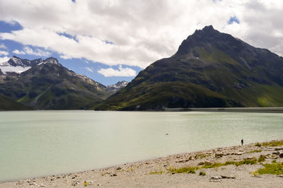 Scenic view of lake and mountains against sky