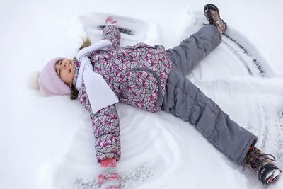 High angel view of girl on snow covered land