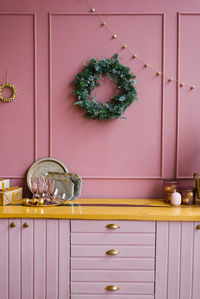The concept of the winter holidays. festive christmas decorations in the pink kitchen