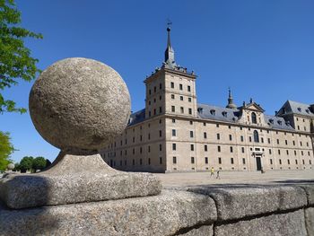 Low angle view of historic building against clear blue sky