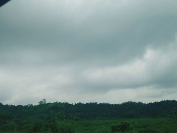 Scenic view of landscape against cloudy sky