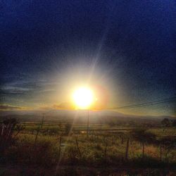 Scenic view of field against sky during sunset