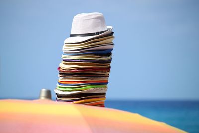 Close-up of multi colored stack against blue sky