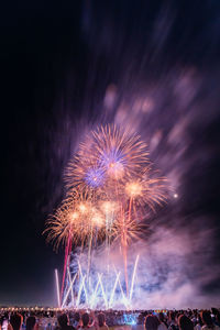 Low angle view of firework display at night