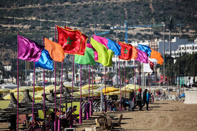 Multi colored flags hanging on beach