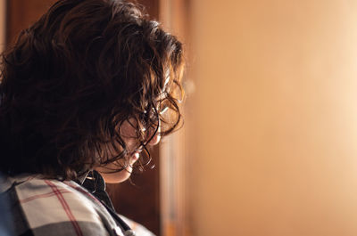 Rear view of boy looking at camera