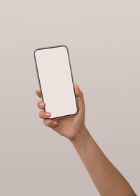 Low angle view of person using smart phone against white background