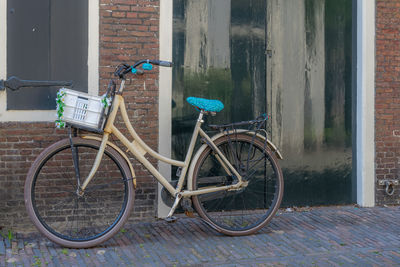 Bicycle parked against building