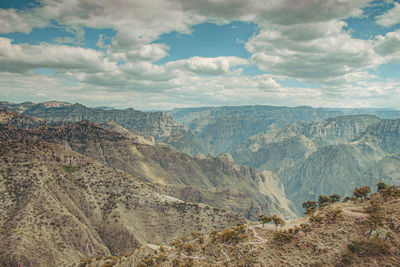 Scenic view of dramatic landscape against cloudy sky