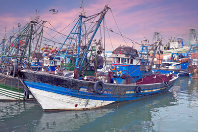 Fishing boats at the harbor from essaouria in morocco at sunset